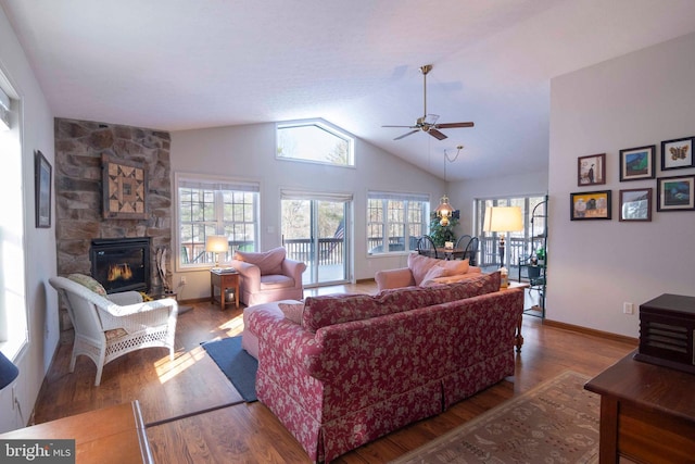 living room with lofted ceiling, a fireplace, hardwood / wood-style floors, and ceiling fan