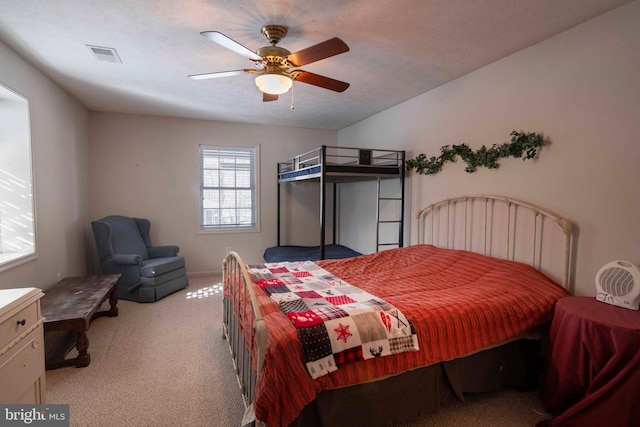 carpeted bedroom with a textured ceiling and ceiling fan