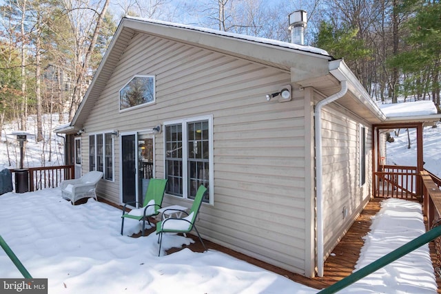 view of snowy exterior with a deck