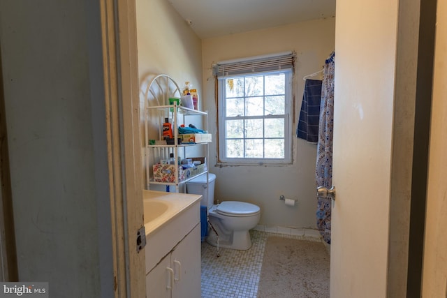 bathroom with a shower with curtain, vanity, toilet, and tile patterned flooring