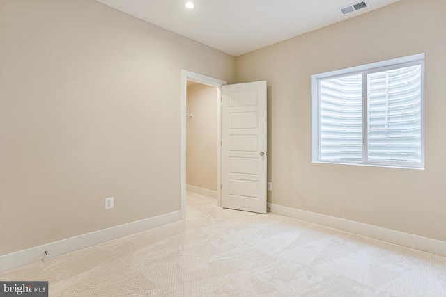 empty room featuring light carpet