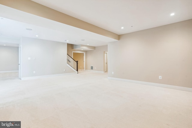 unfurnished room with light colored carpet