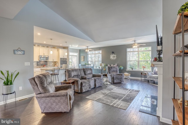 living room featuring ceiling fan, dark hardwood / wood-style flooring, high vaulted ceiling, and sink