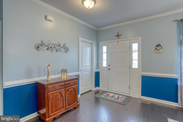 foyer entrance with crown molding and dark wood-type flooring