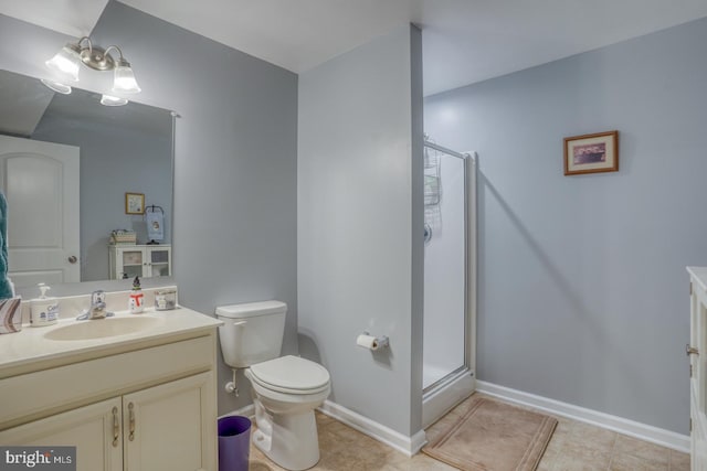 bathroom featuring toilet, a shower with door, vanity, and tile patterned flooring