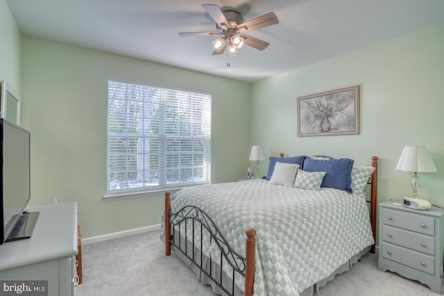 bedroom featuring light colored carpet and ceiling fan