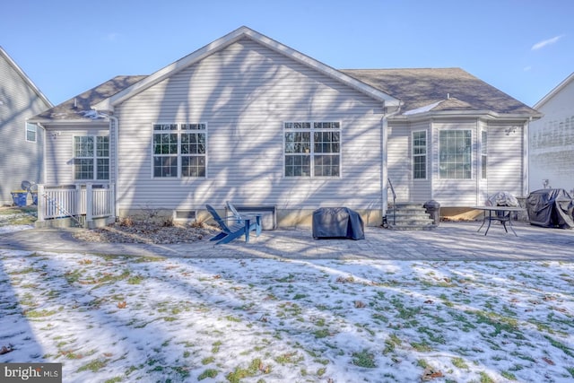 view of snow covered rear of property