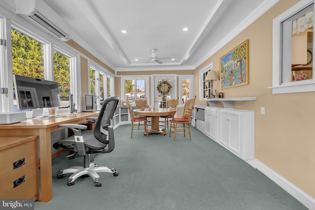 carpeted office with ceiling fan, a wall mounted AC, a tray ceiling, and ornamental molding