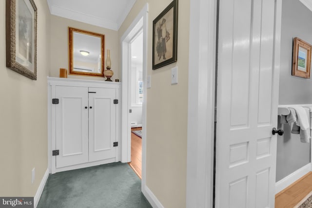 hall featuring crown molding and dark colored carpet