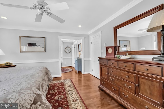 bedroom with crown molding, dark hardwood / wood-style floors, and ceiling fan