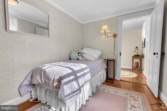 bedroom featuring light hardwood / wood-style flooring and ornamental molding