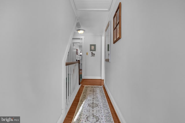 corridor featuring crown molding and wood-type flooring