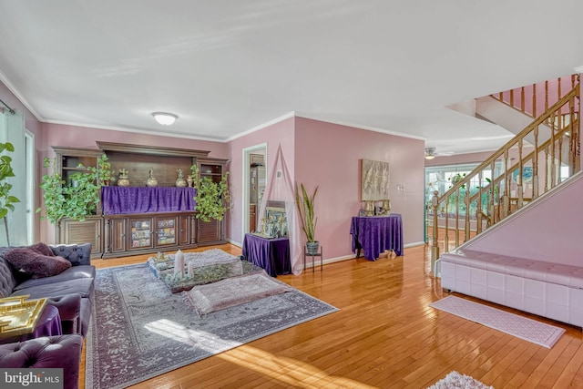 living room with ornamental molding and hardwood / wood-style floors