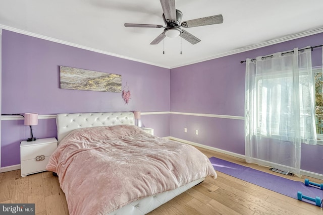 bedroom with ceiling fan, crown molding, and hardwood / wood-style floors