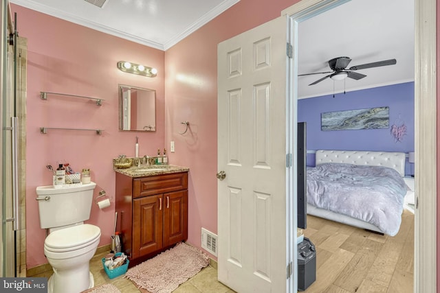 bathroom with toilet, crown molding, vanity, ceiling fan, and hardwood / wood-style flooring