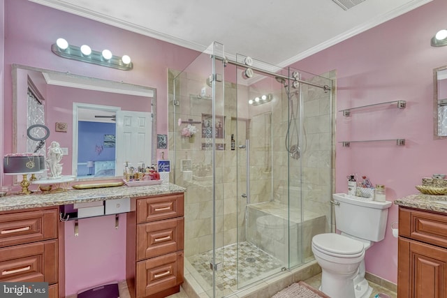 bathroom featuring a shower with shower door, toilet, tile patterned floors, vanity, and crown molding