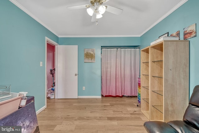 interior space with light wood-type flooring, ceiling fan, and ornamental molding