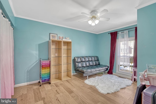 sitting room with ceiling fan, light hardwood / wood-style floors, and ornamental molding