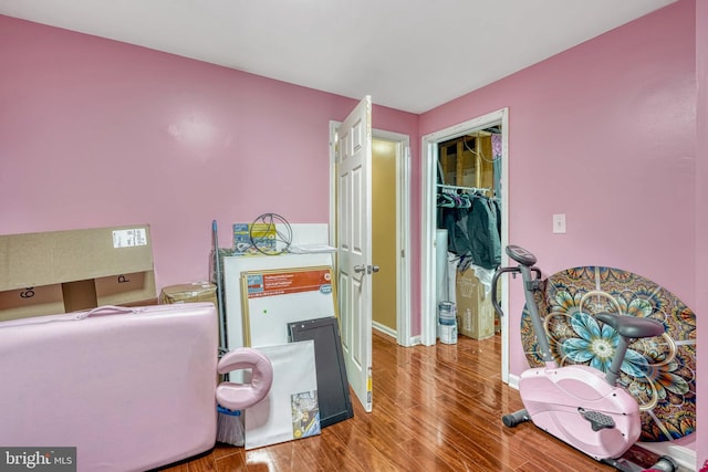 bedroom with a closet and hardwood / wood-style flooring