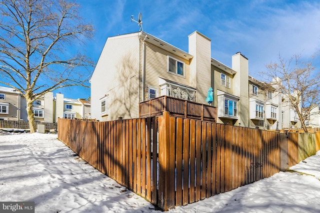 view of snow covered rear of property