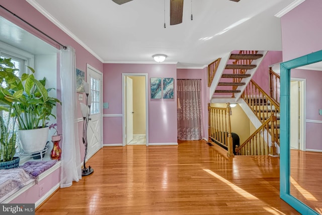 interior space with ceiling fan, crown molding, and hardwood / wood-style flooring