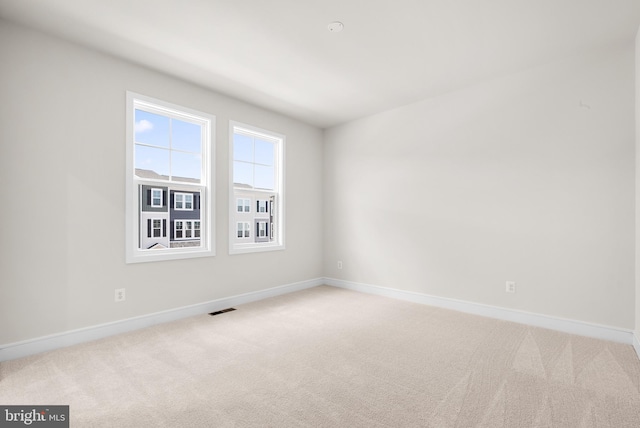 unfurnished room with light carpet