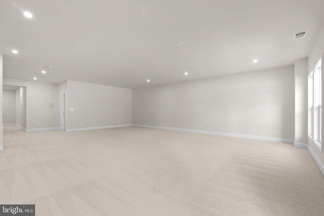 empty room with a healthy amount of sunlight and light colored carpet