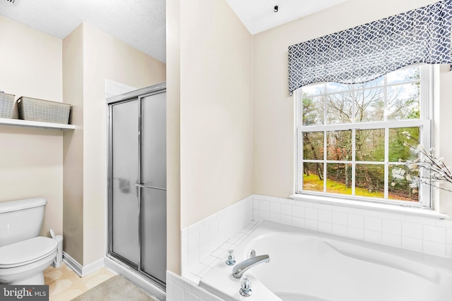 bathroom featuring toilet, a textured ceiling, and separate shower and tub