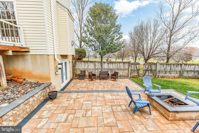 view of patio featuring an outdoor living space with a fire pit