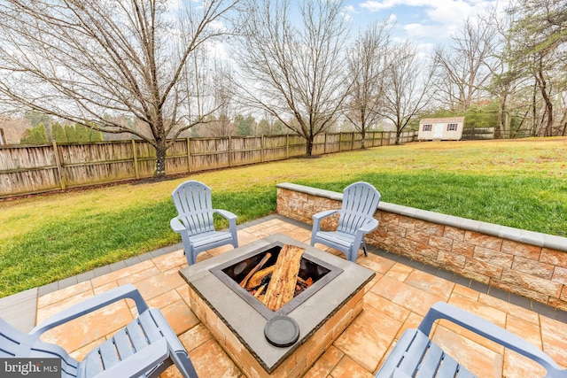 view of patio featuring a fire pit and a shed