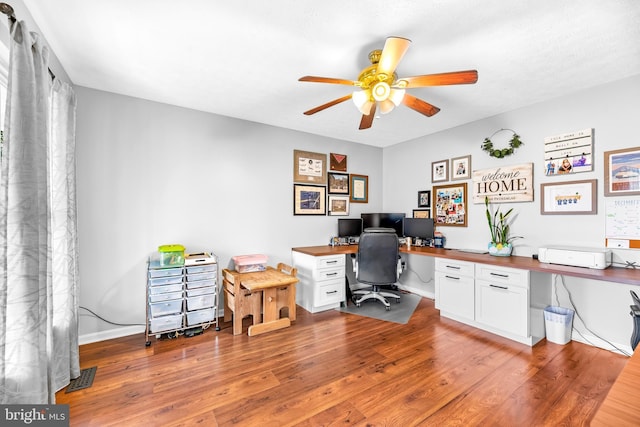 home office with ceiling fan and light hardwood / wood-style flooring