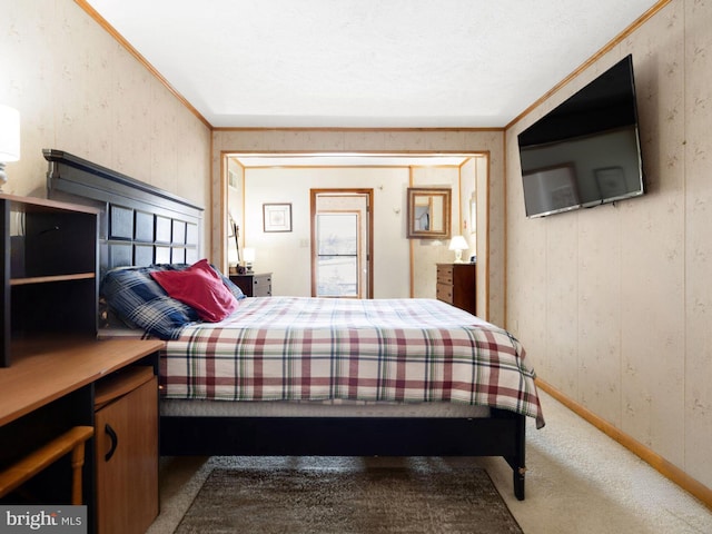 carpeted bedroom featuring crown molding