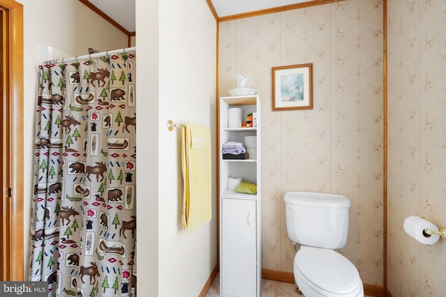 bathroom featuring toilet, ornamental molding, and walk in shower