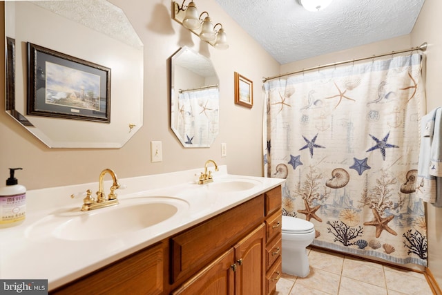 bathroom with toilet, a shower with shower curtain, tile patterned flooring, a textured ceiling, and vanity