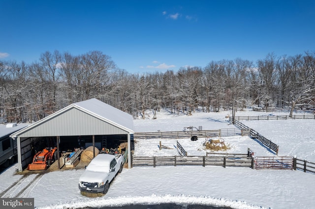 snowy yard featuring an outdoor structure