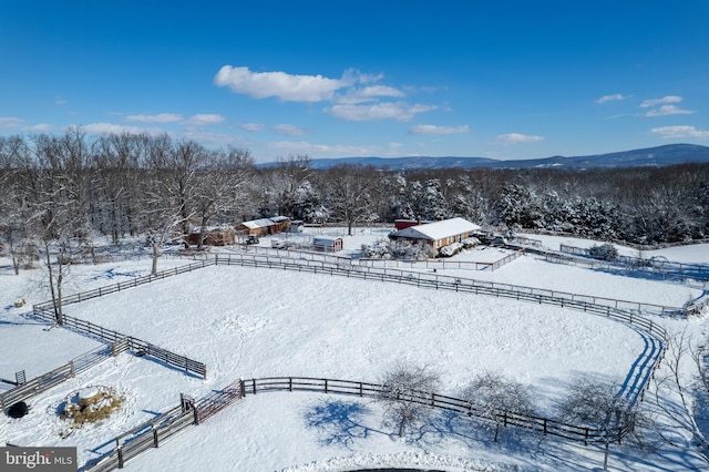 snowy aerial view with a mountain view