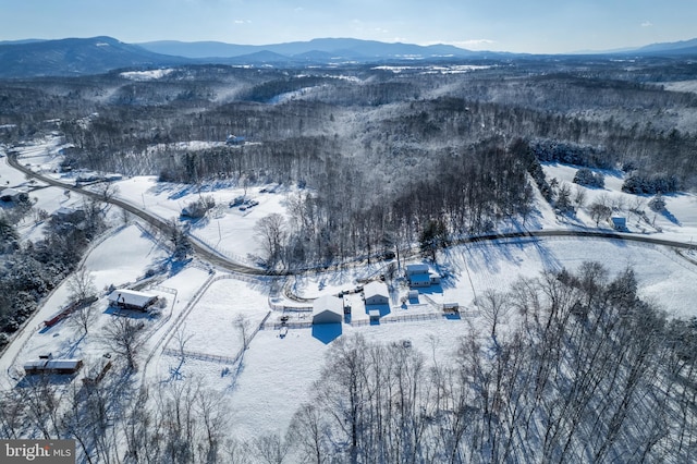 snowy aerial view featuring a mountain view