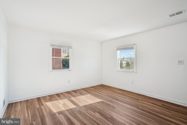 spare room with wood-type flooring