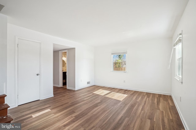 interior space featuring connected bathroom and dark hardwood / wood-style flooring