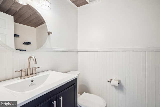 bathroom featuring toilet, vanity, and wood ceiling