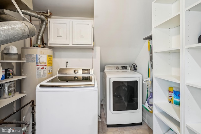 clothes washing area featuring washing machine and dryer and water heater