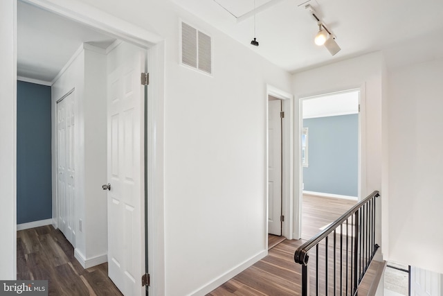 hall featuring dark hardwood / wood-style flooring and ornamental molding