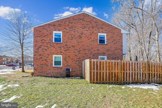 view of side of home with a yard