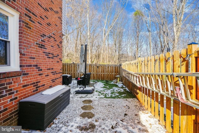 snowy yard with a patio area