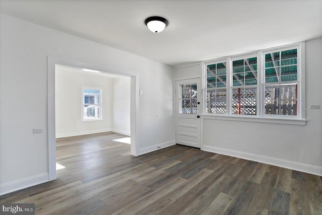 spare room featuring dark wood-type flooring