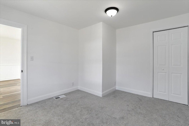 empty room with light colored carpet