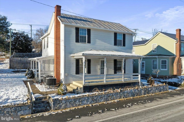 view of property featuring cooling unit and a porch