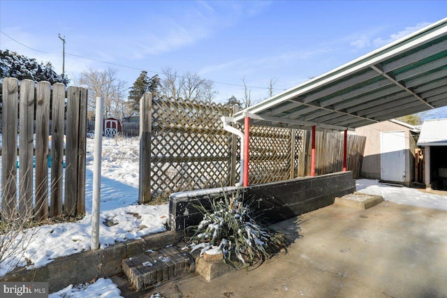 exterior space with a storage shed and a carport