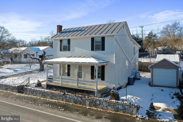 view of front facade featuring an outdoor structure, a porch, and a garage