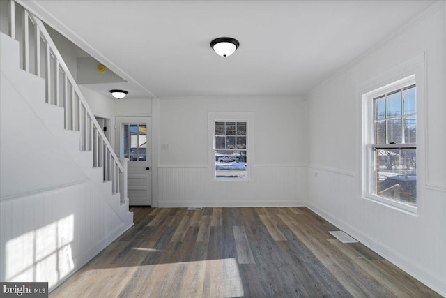 entryway with dark hardwood / wood-style flooring